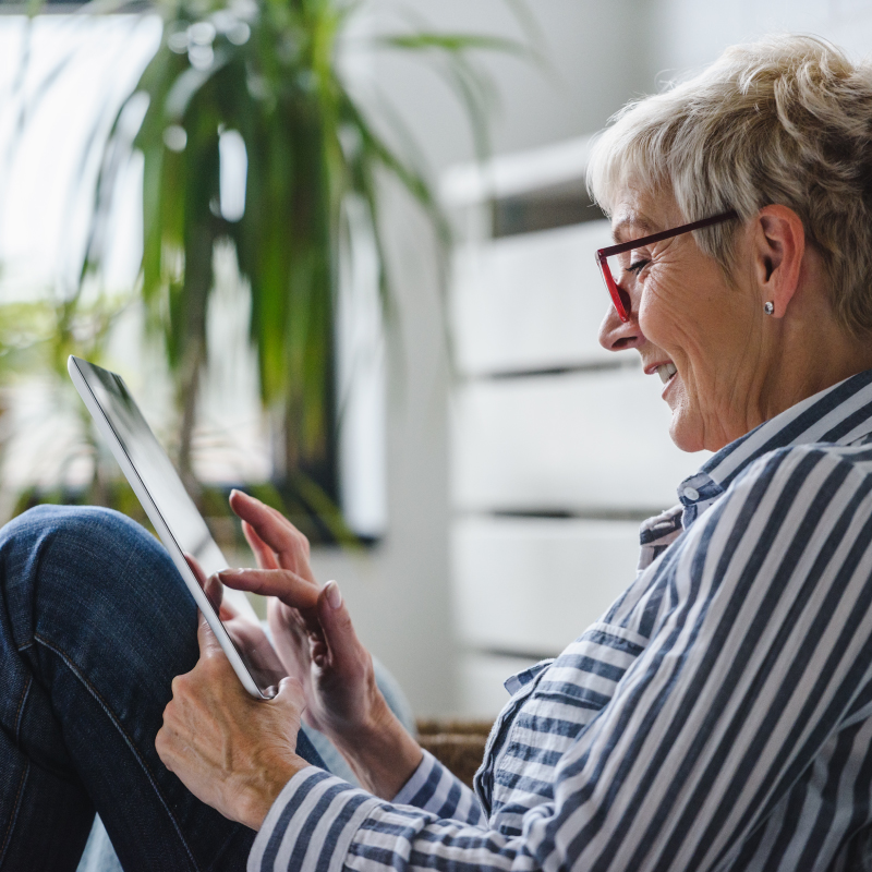 woman smiling looking at iPad - funeral directors croydon